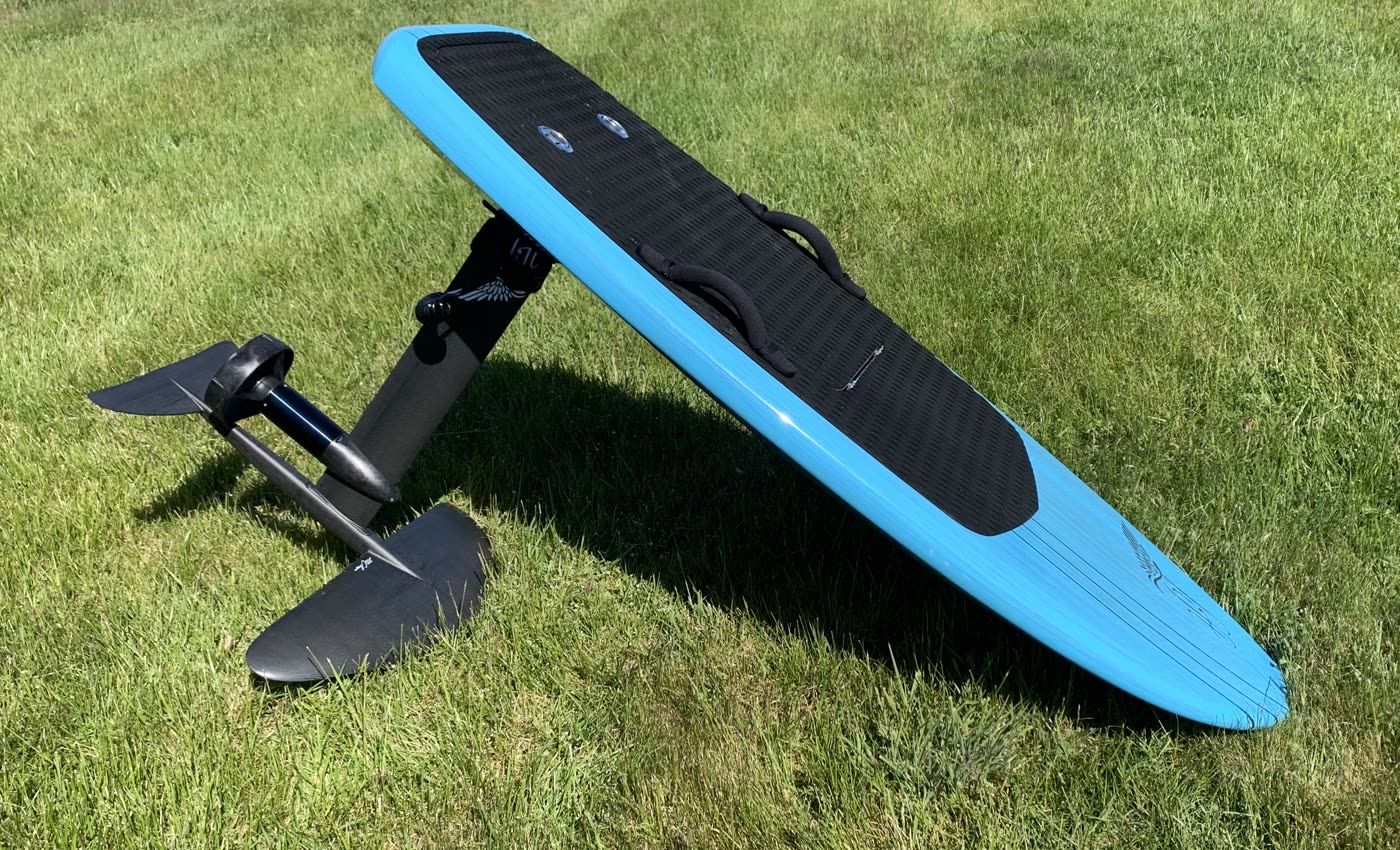 eFoil board with the hydrofoil mast and wings, ready on the grass before a lesson