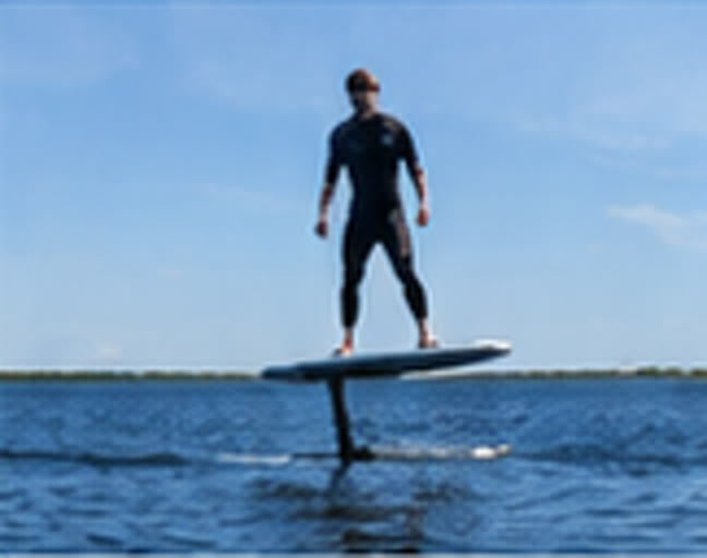 Rider flying above the water on the hydrofoil
